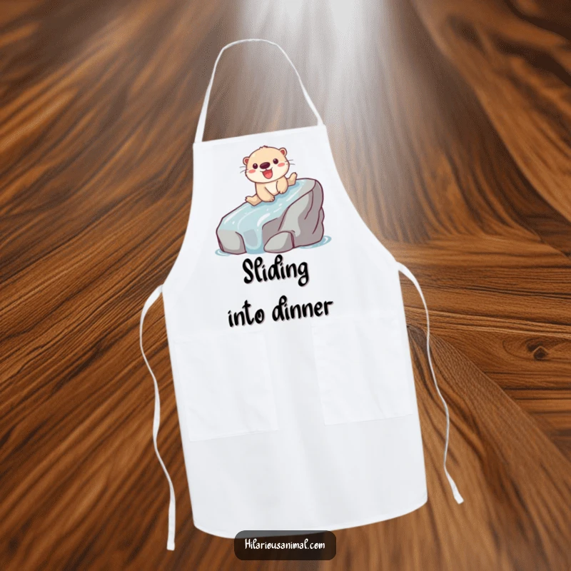 Funny apron featuring a playful otter gleefully sliding down a slippery rock while cooking.