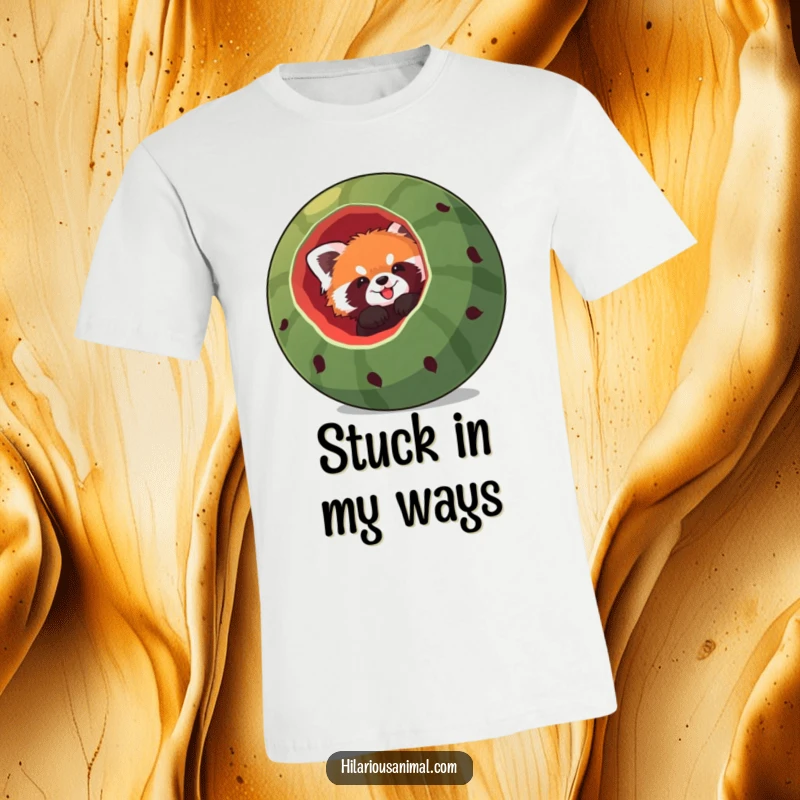 Funny red panda t-shirt, a red panda comically stuck headfirst in a large, hollowed-out watermelon, expressing a mix of surprise and amusement.
